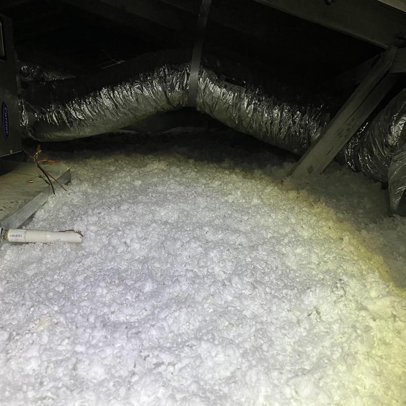 Attic blown-in insulation with HVAC ductwork above