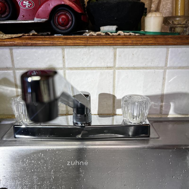 Kitchen faucet with clear handles installed on sink