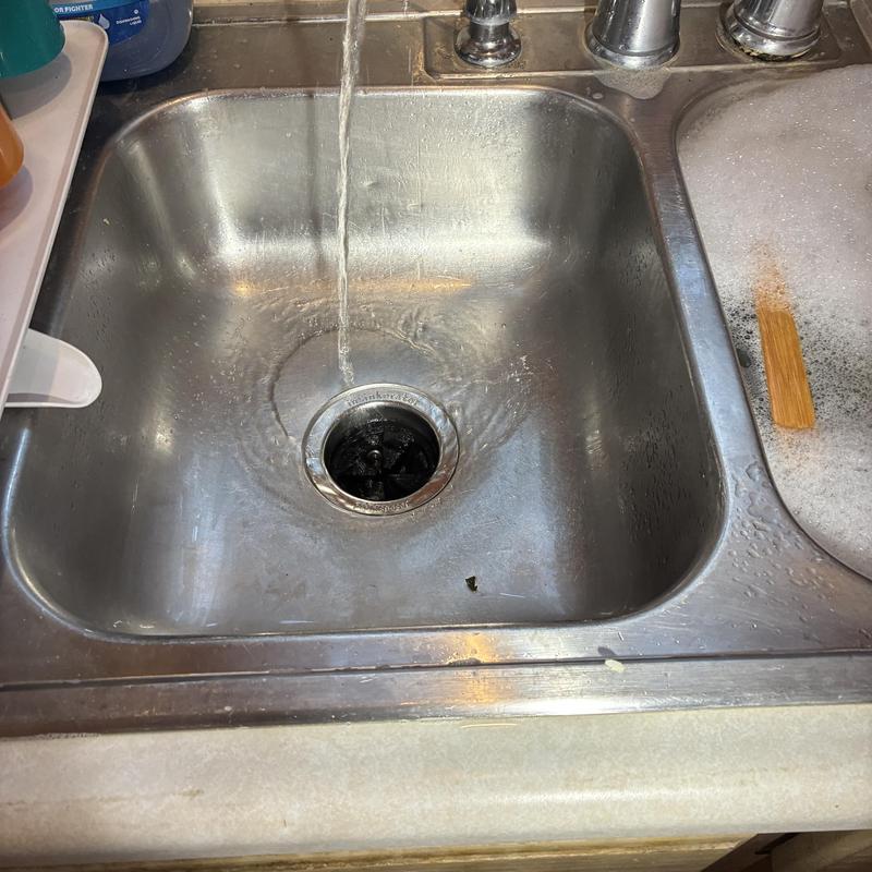Garbage disposal with running water in kitchen sink