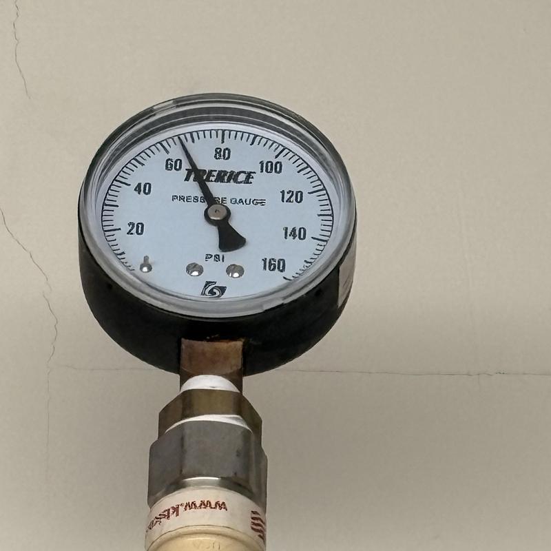 Dishwasher water pressure gauge showing 60 PSI