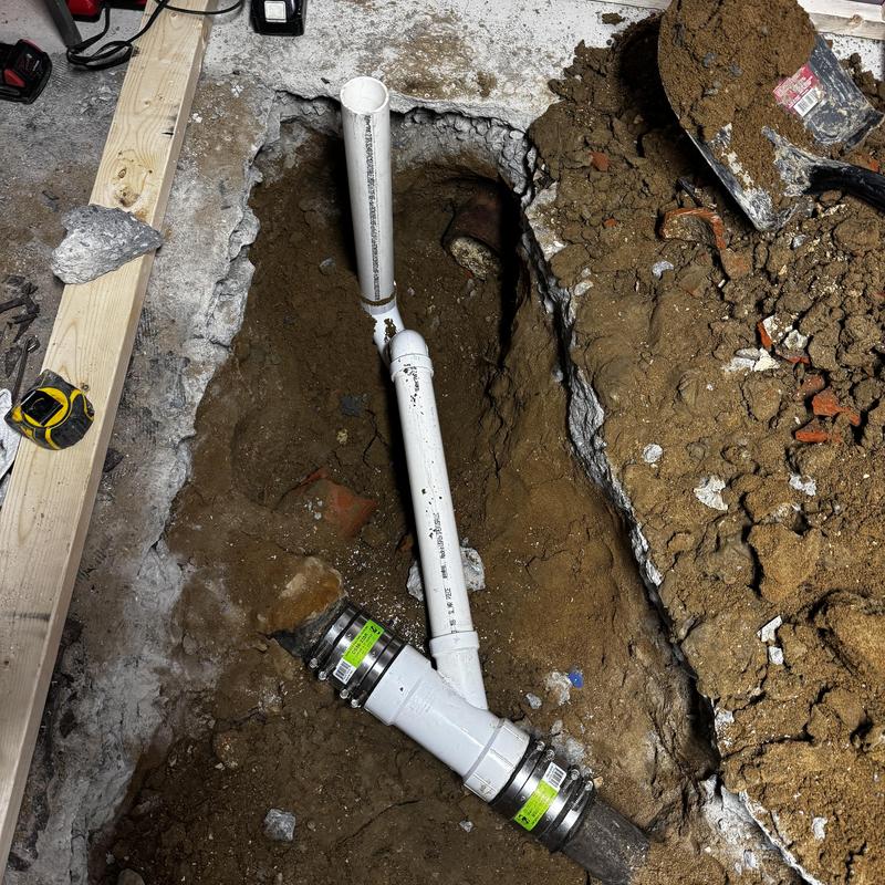Shower drain pipe connected to cast iron sewer line