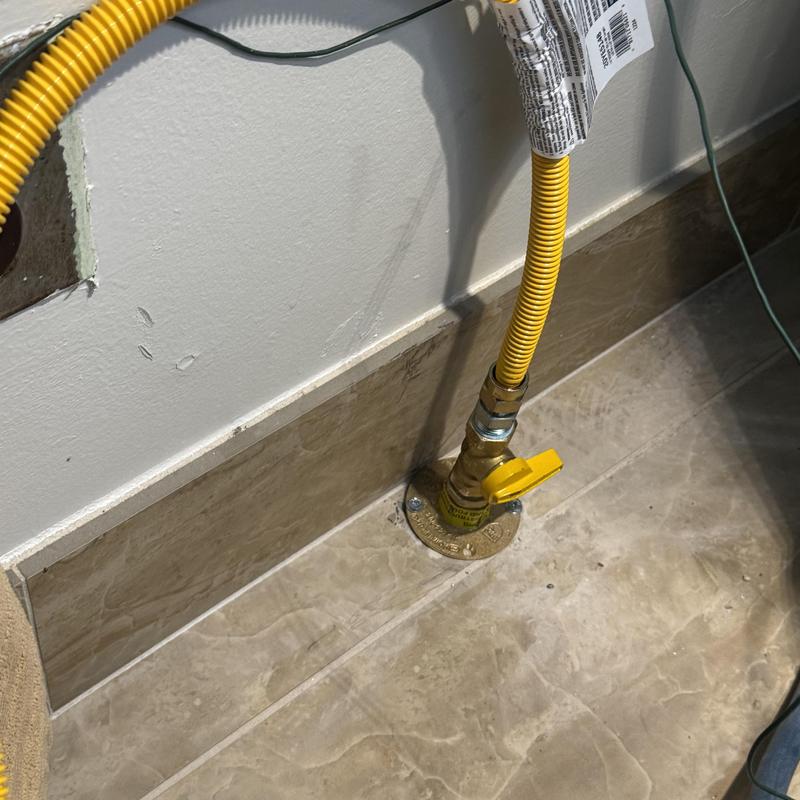 CSST gas line with termination flange installation