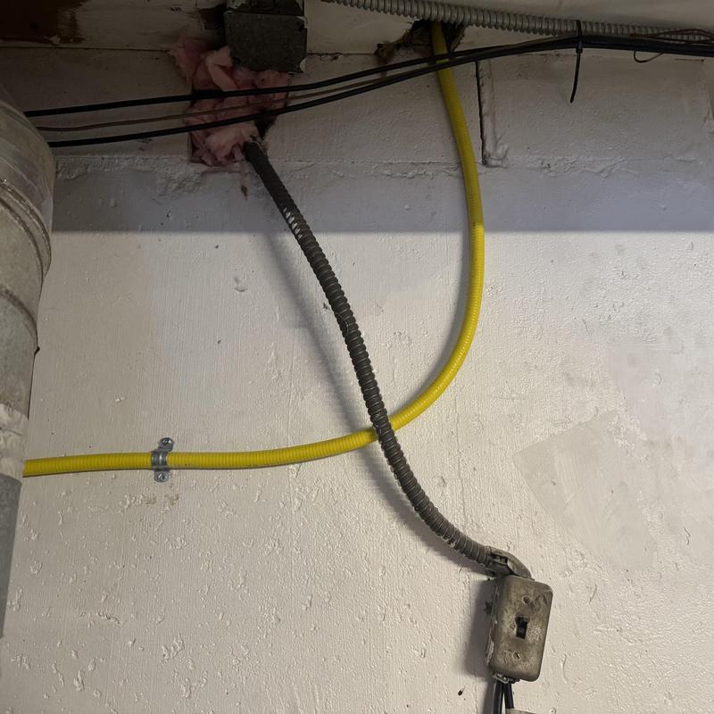 CSST gas line with termination flange and gas whip installation