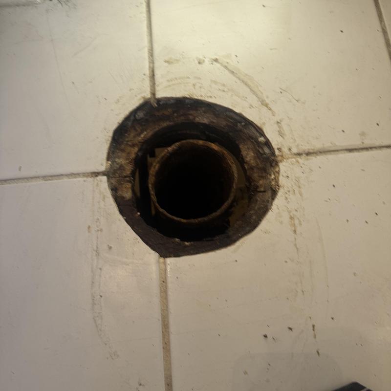 Cast iron toilet flange replacement on tiled floor