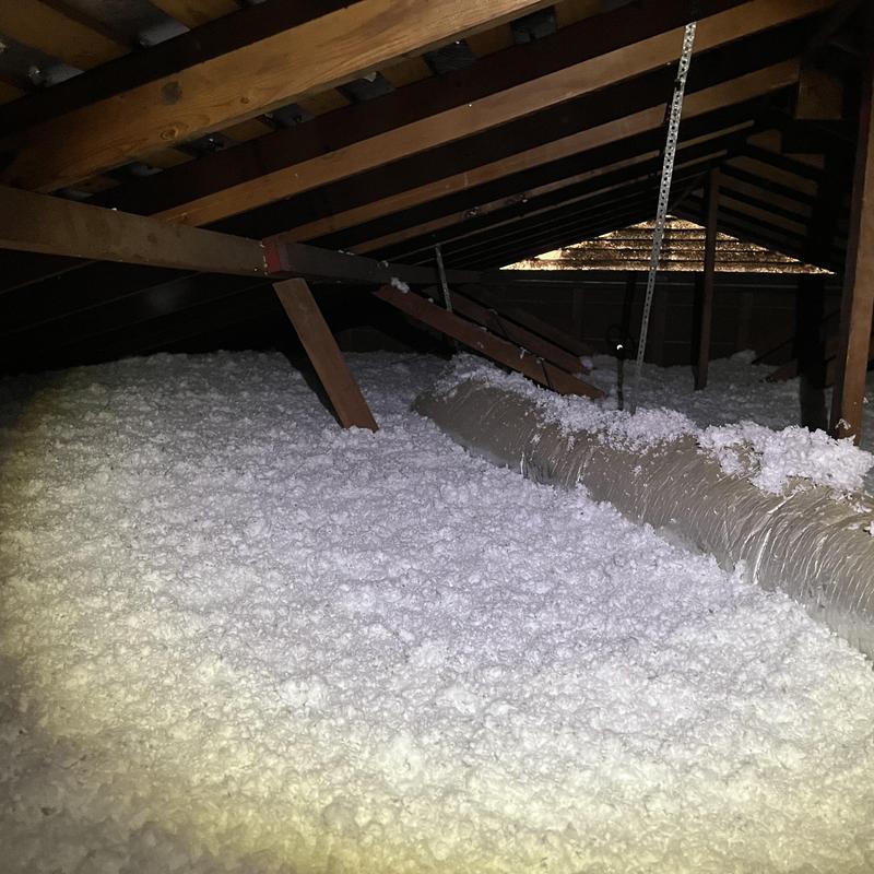 Attic blown-in insulation around HVAC ductwork