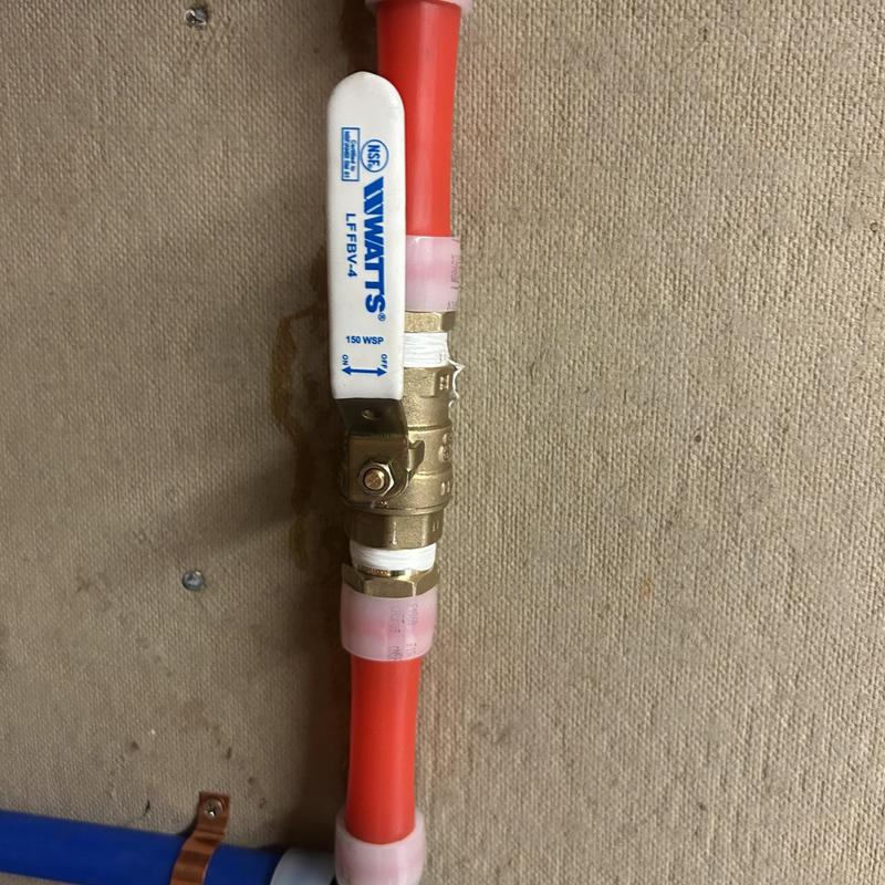Ball valve with red PEX piping installation