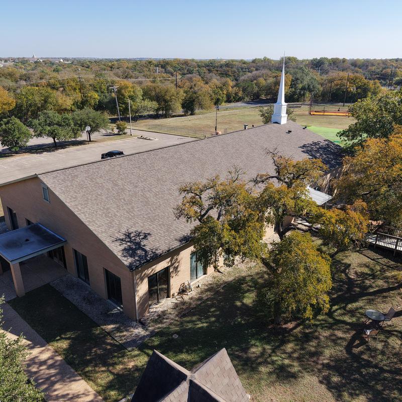 Church roof with replaced shingles in Austin, TX