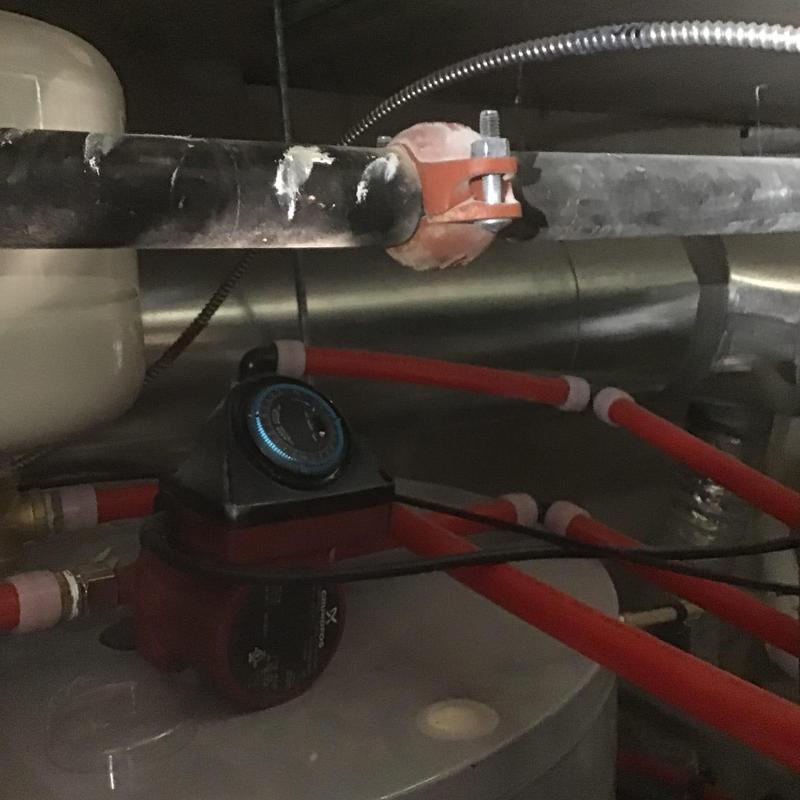 250-gallon water heater circulation pump with red piping