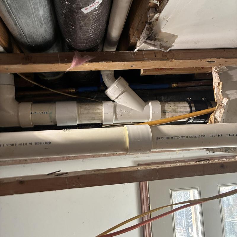 PVC drain pipe system in ceiling with repairs