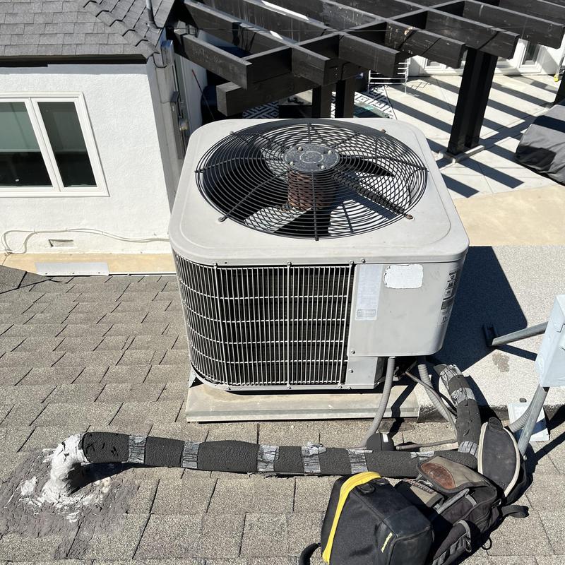 ML14KC1 condenser unit with insulated refrigerant lines on roof