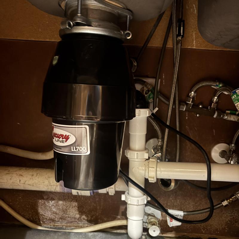 Garbage disposal unit under kitchen sink installation