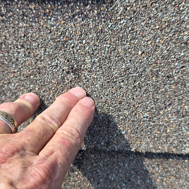 Asphalt roof shingles with hail damage close-up
