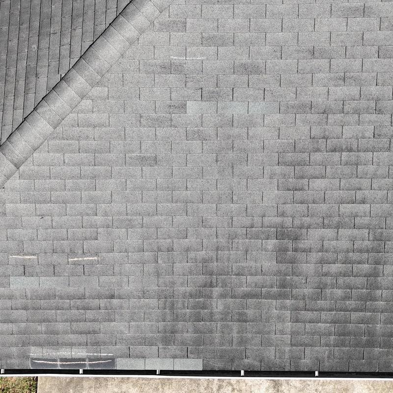 Asphalt shingle roof with visible wear and damage