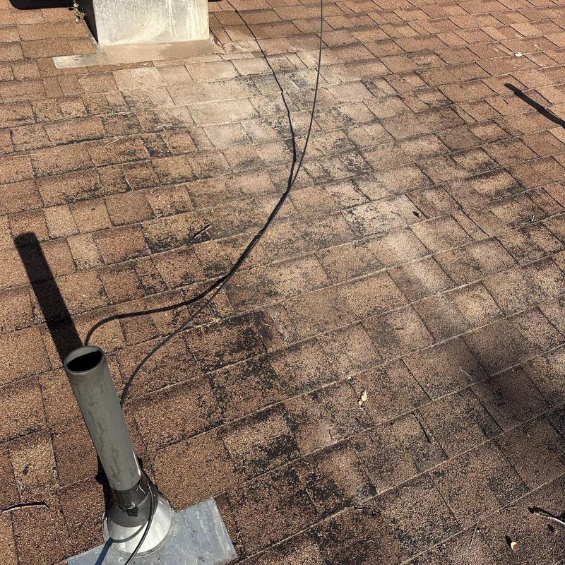 Asphalt shingle roof with vent pipe and cable on top