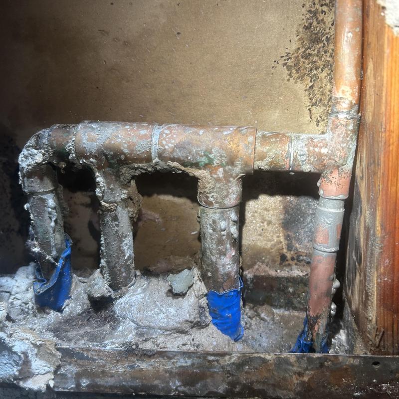 Corroded copper water pipes with corrosion and residue buildup