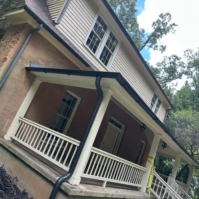 Gutter and downspout system on house exterior