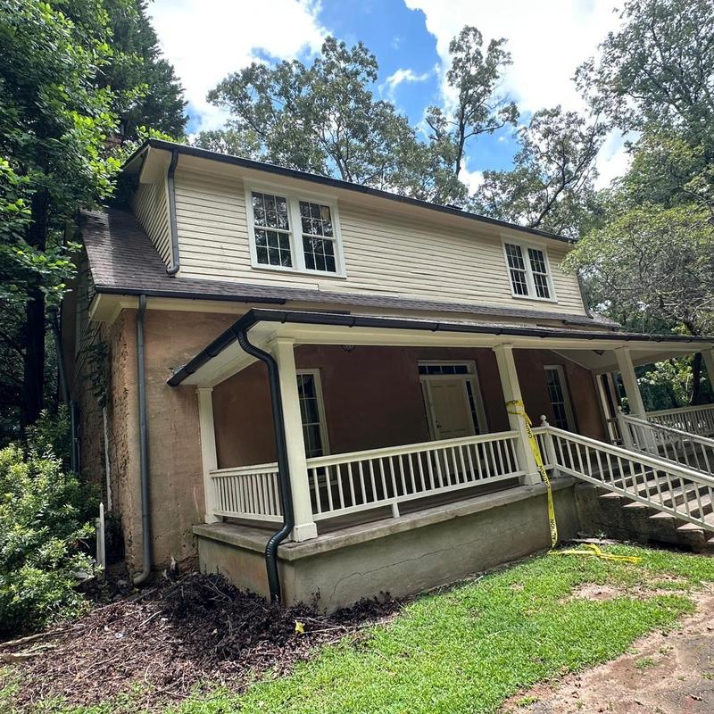 Gutters and downspouts on residential porch roof