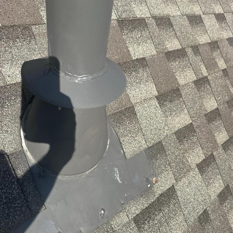 Furnace vent flashing and resealed roof shingles