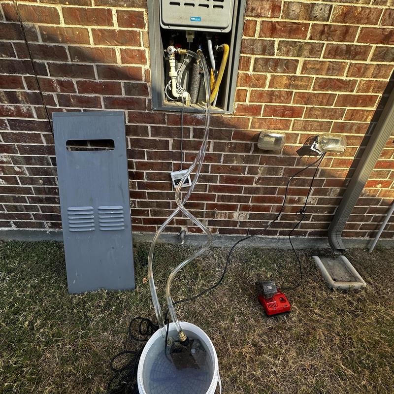 Tankless water heater flushing with pump and tubing