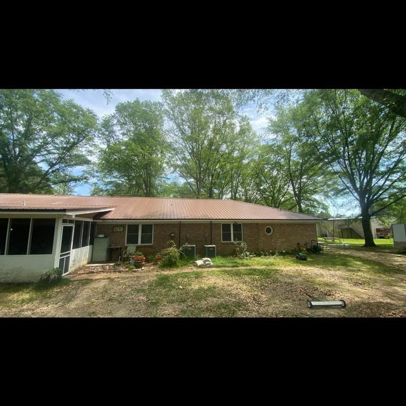 Metal roof system on single-story brick house