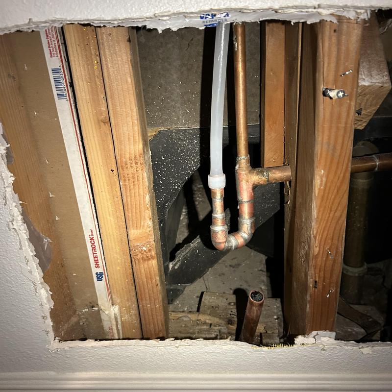 Copper manifold and rerouted Aquaplex piping inside wall