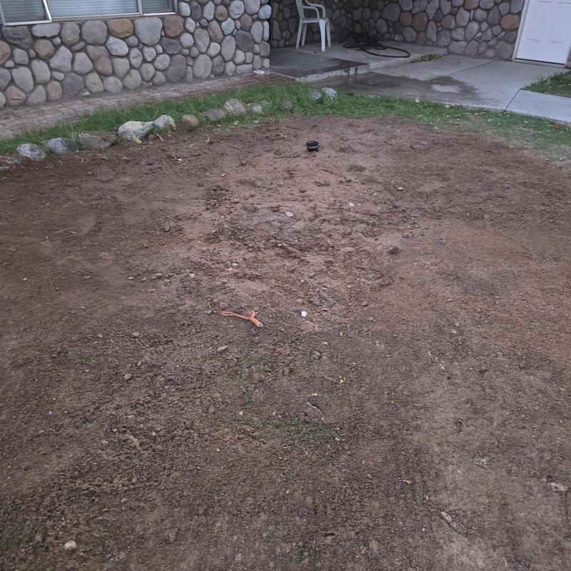 Drain pipe excavation and yard backfill near porch