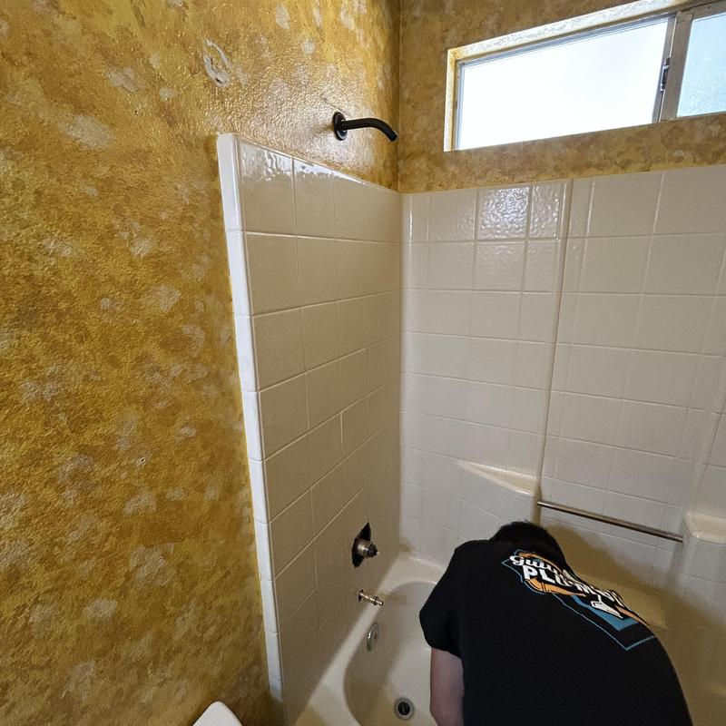 Shower valve installation with copper piping in bathroom