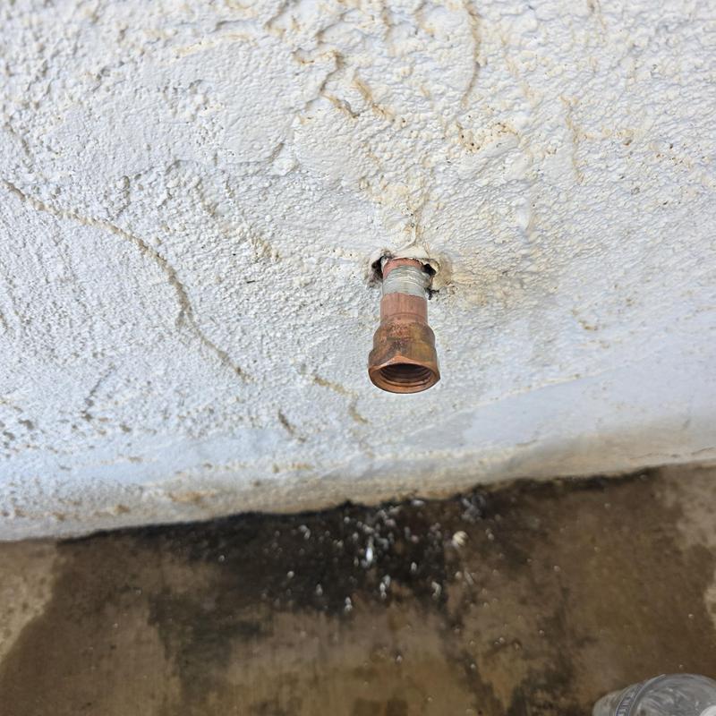 Threaded hose bib with copper adapter on stucco wall