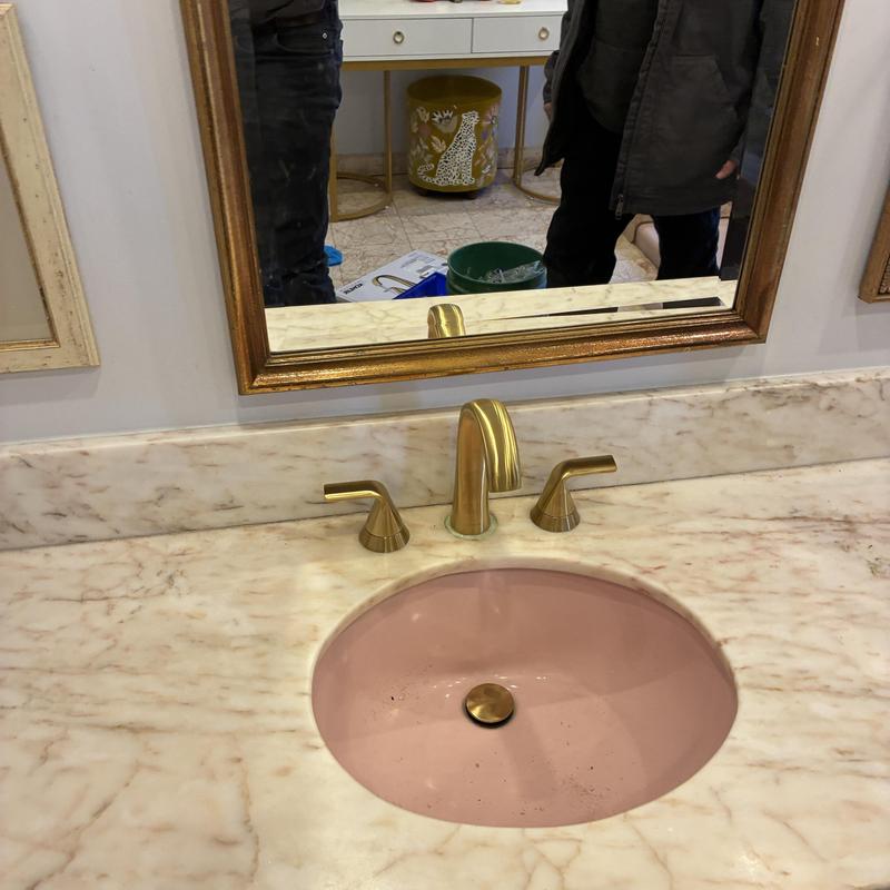 Widespread lavatory faucet installed on marble countertop