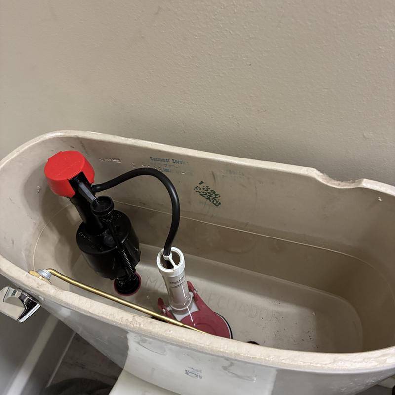 Toilet tank flush valve and fill valve assembly inside