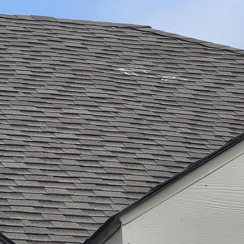 Asphalt shingle roof with marked hail storm damage