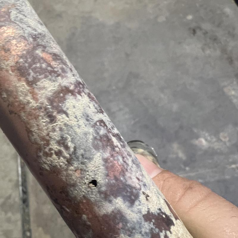 Copper irrigation line with corrosion and small hole Copper irrigation line with corrosion and small hole