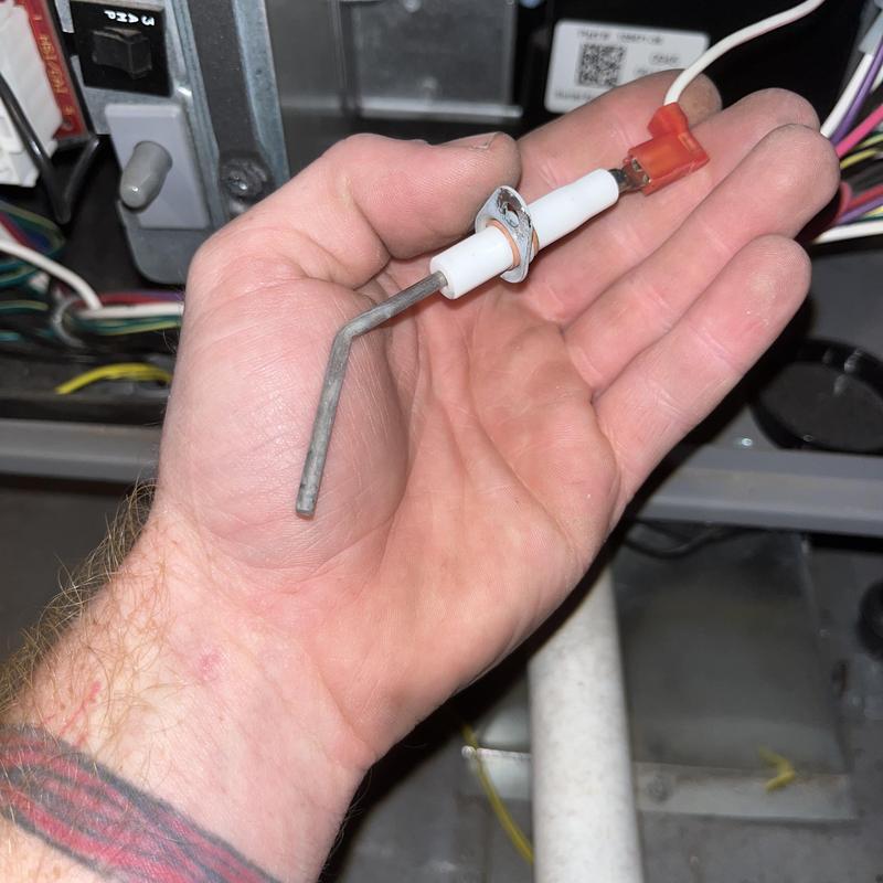 Igniter sensor held in hand during HVAC maintenance