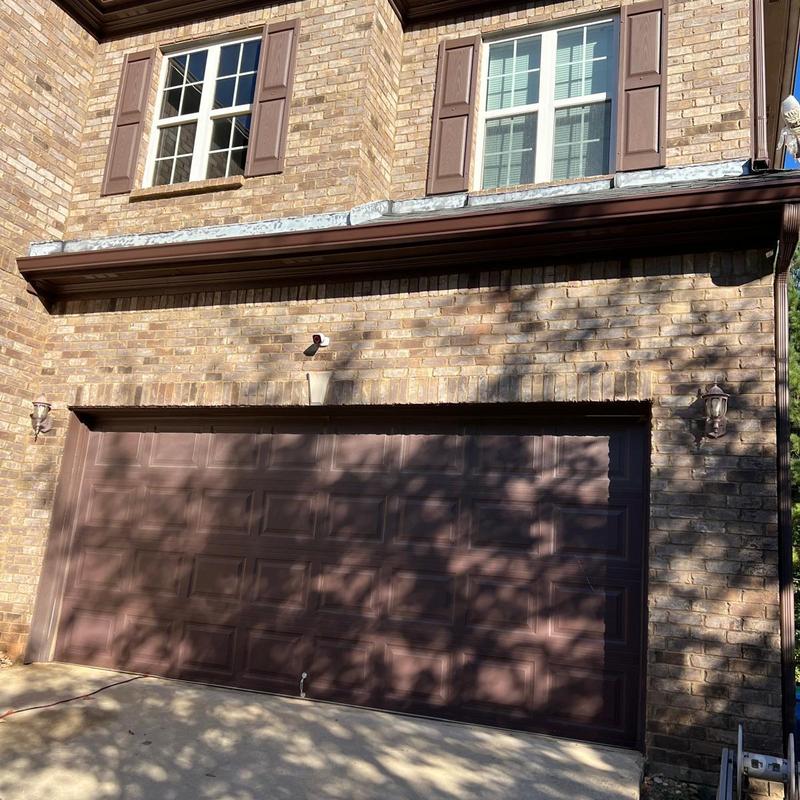 Gutters and downspouts replacement on brick home