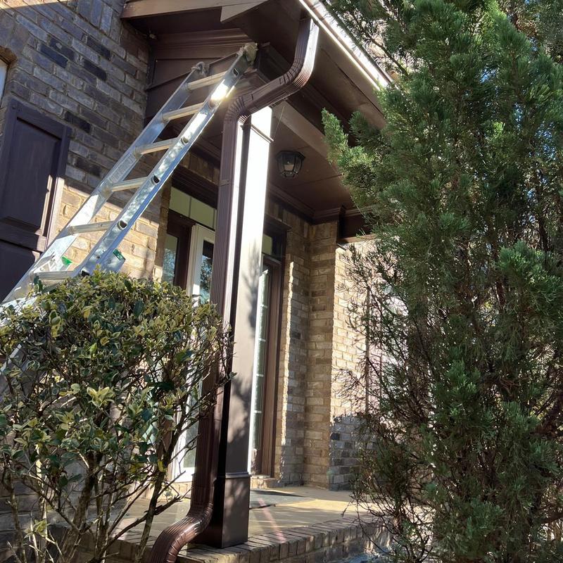 Gutter and downspout system with ladder on porch