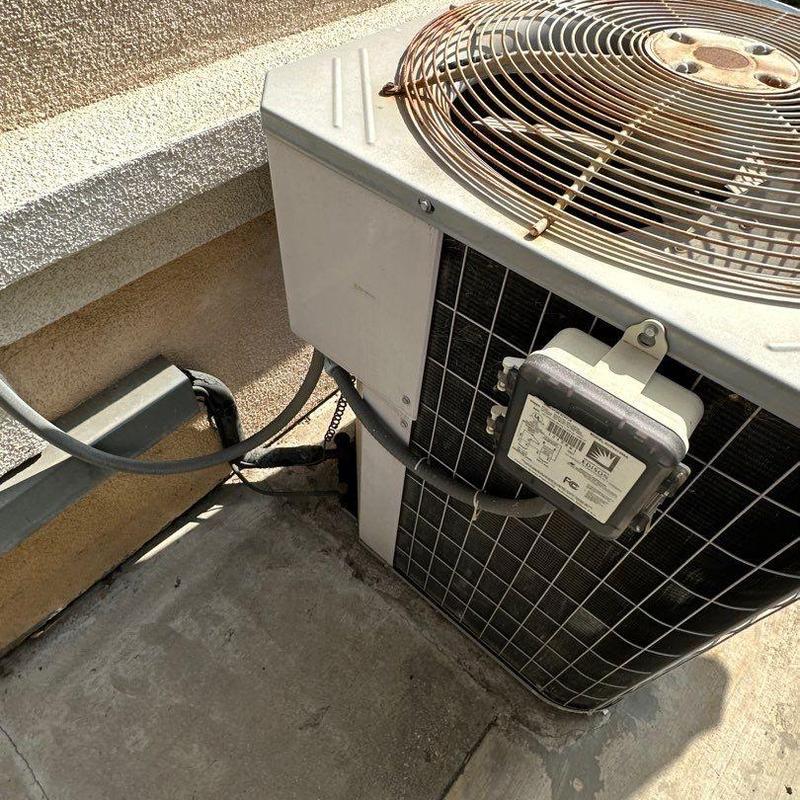 Condenser unit ML14KC1 installed on concrete pad