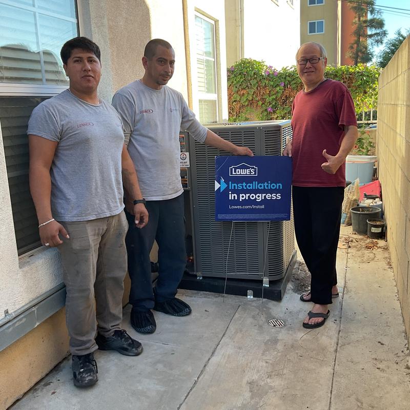 ML14KC1 Condenser installation with technicians posed