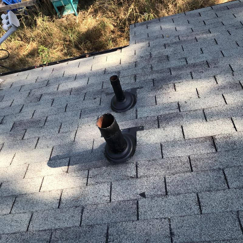 Pipe boots on shingled roof after replacement and resealing