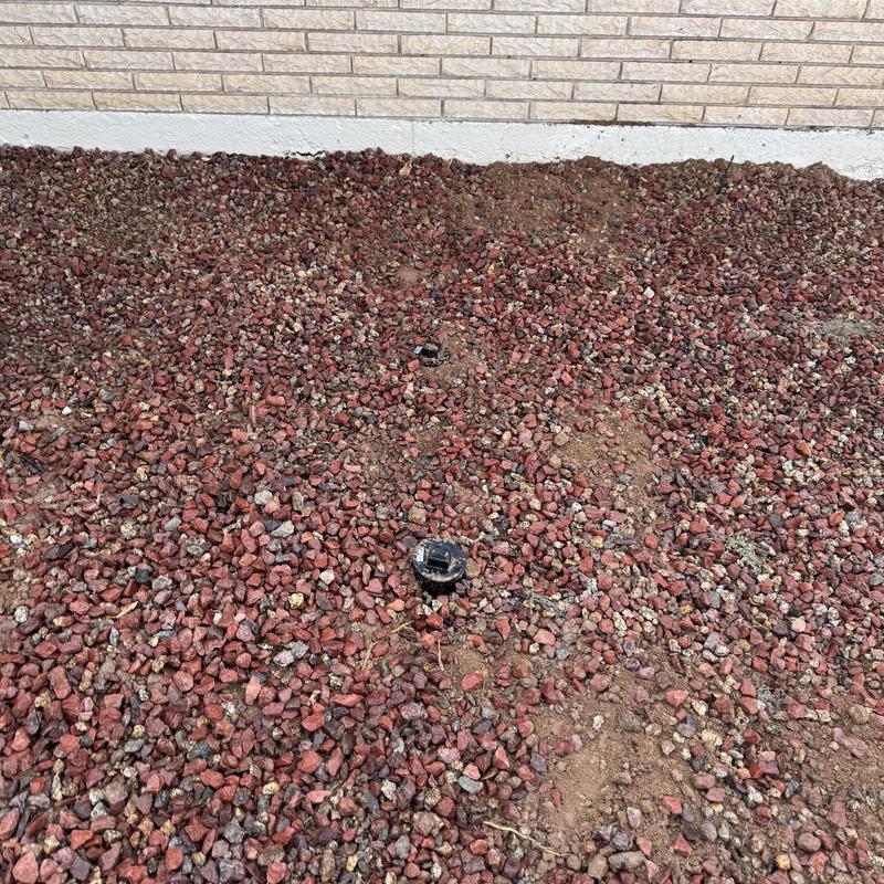 Plumbing clean outs in front yard with gravel cover