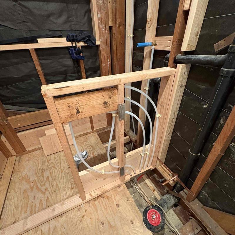 Bathroom PEX water supply piping installation in wall framing
