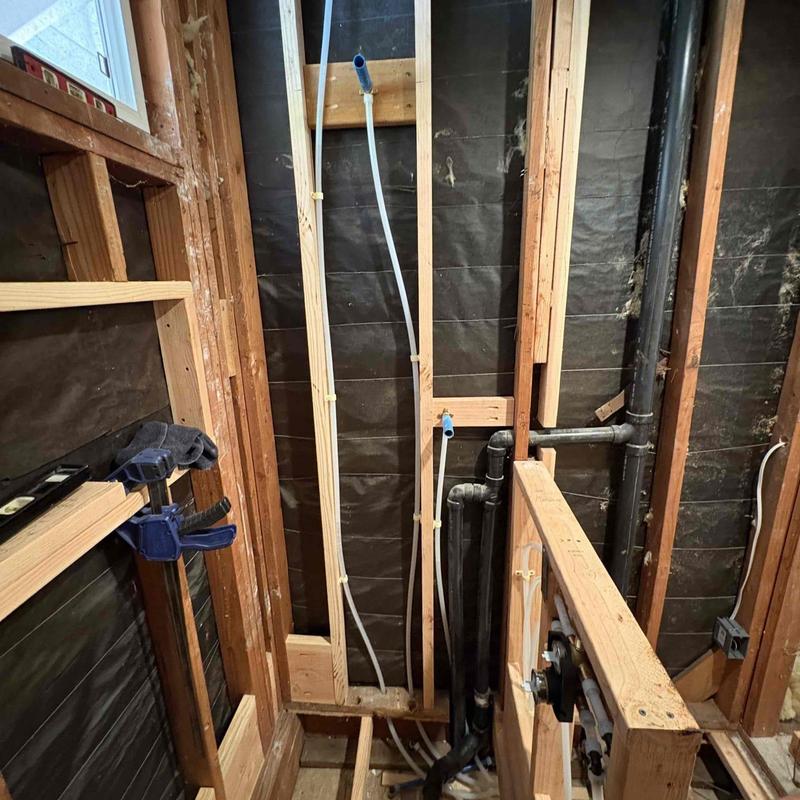 Bathroom plumbing rough-in with drain and supply pipes