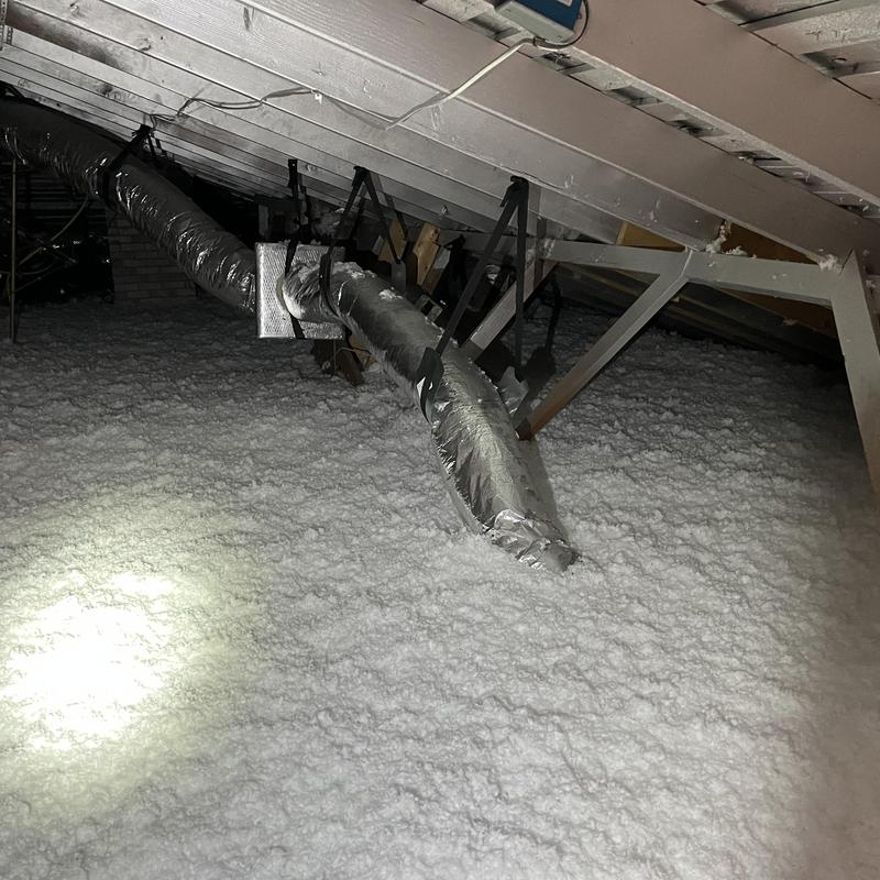 Attic blown-in insulation with HVAC ductwork above