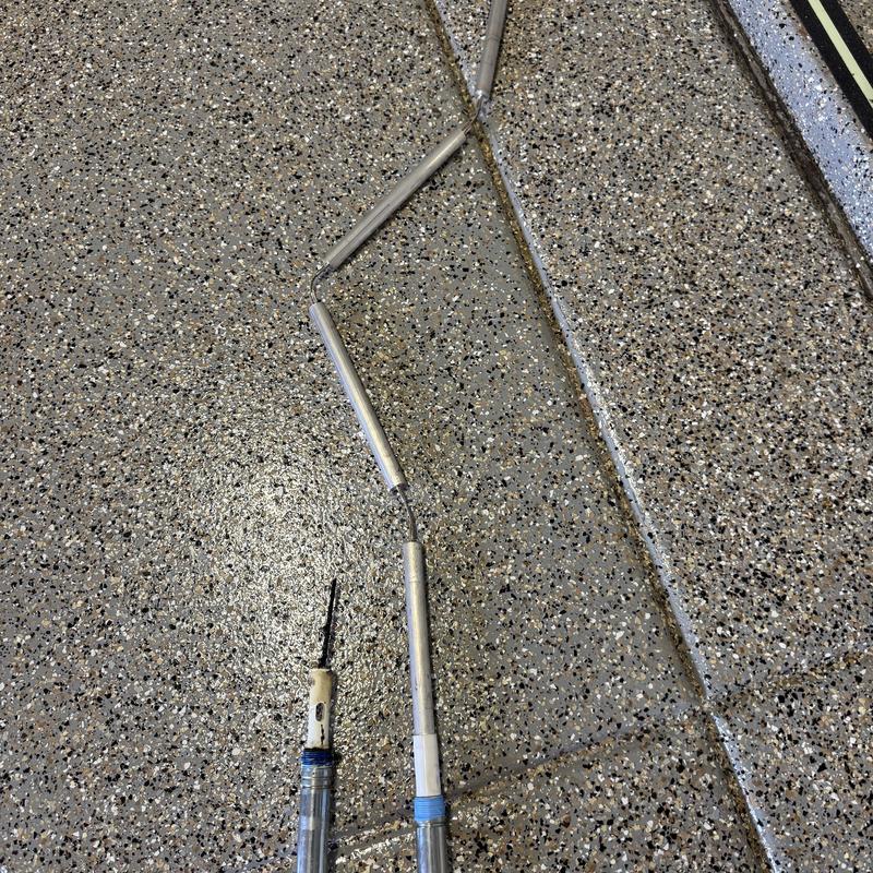 Water heater hand rod replacement on speckled floor