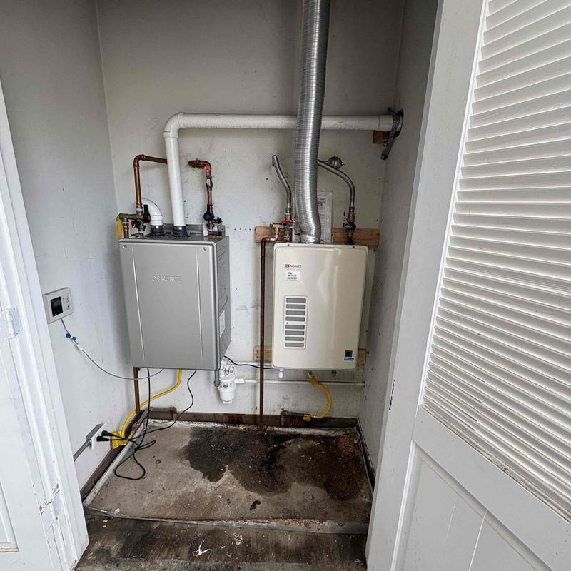 Tankless water heater installed with venting and piping