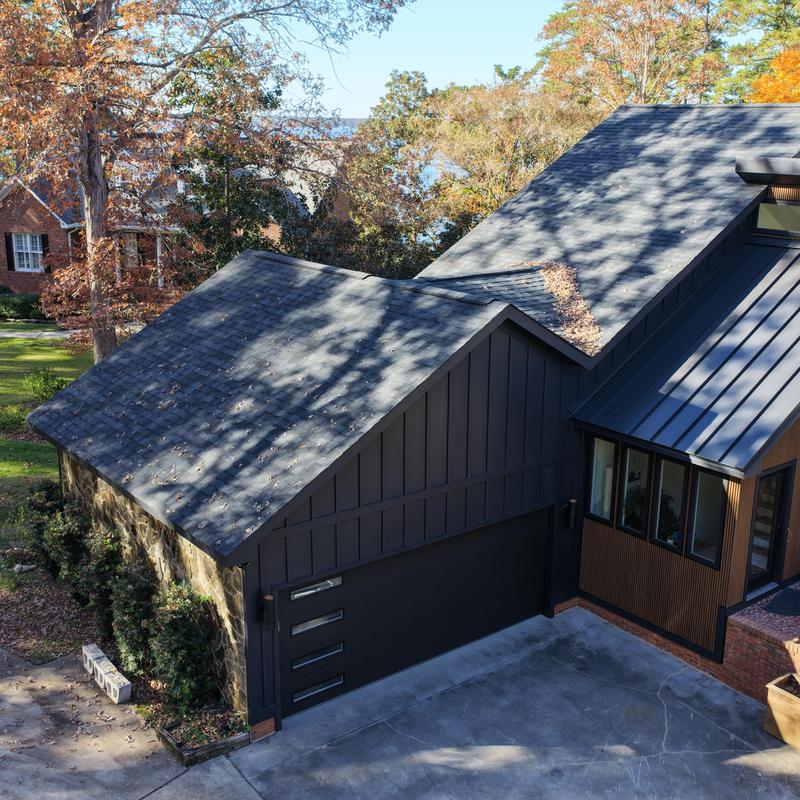 Asphalt shingle roof and modern siding on garage and house