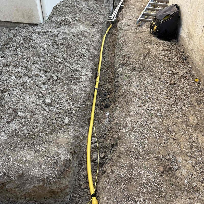Yellow gas line installation in trench for remodel