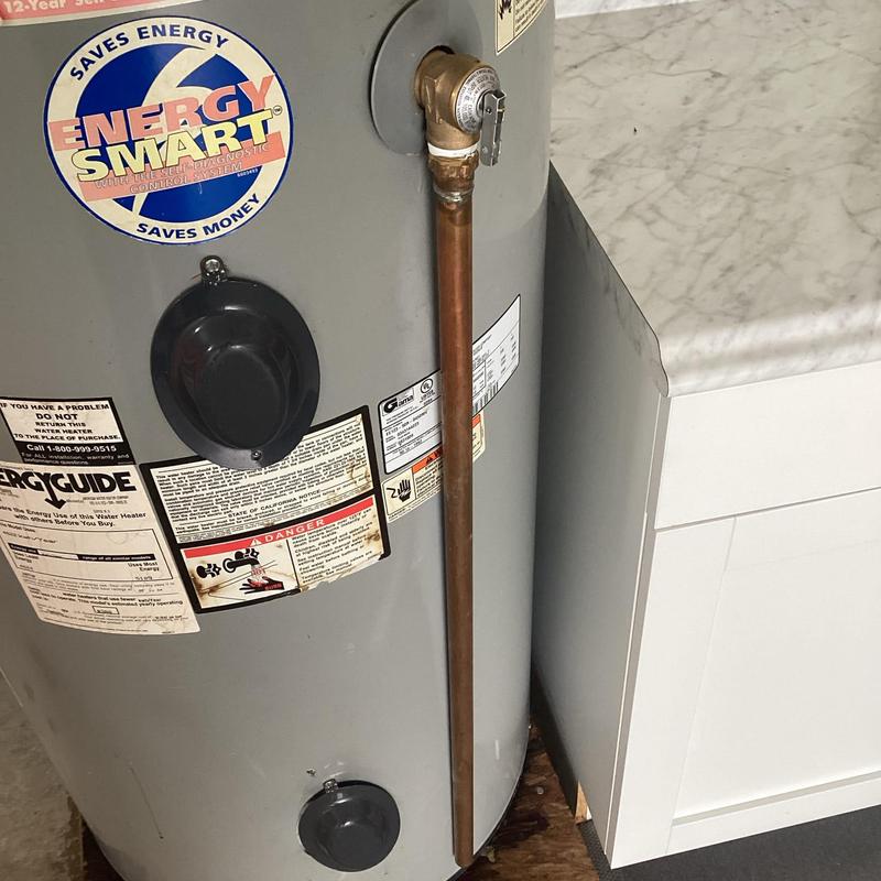 Water heater pop off valve and relief pipe installed