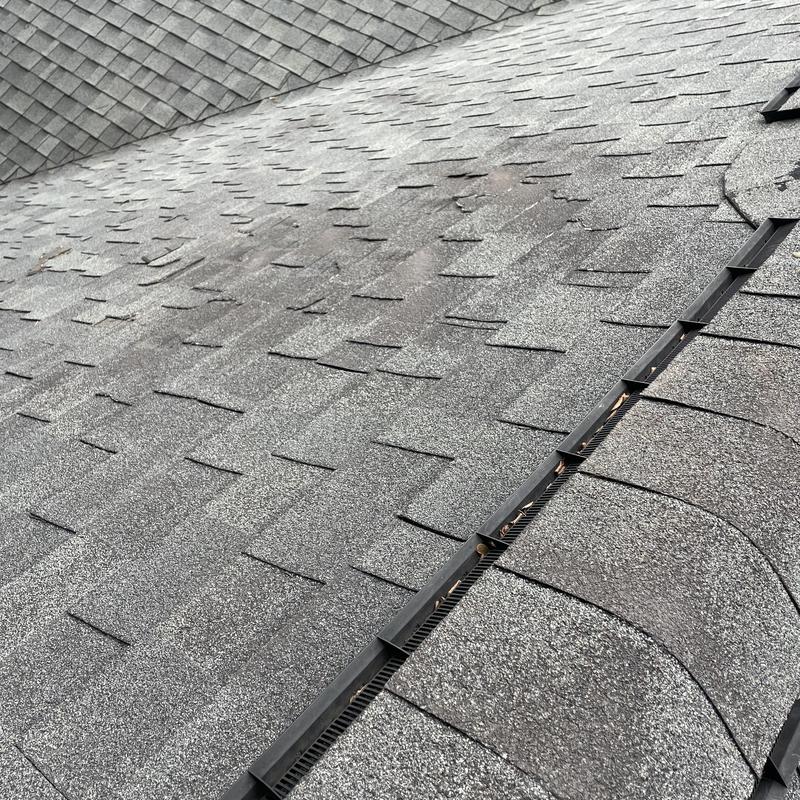 Architectural laminate shingle roof with hail and puncture damage