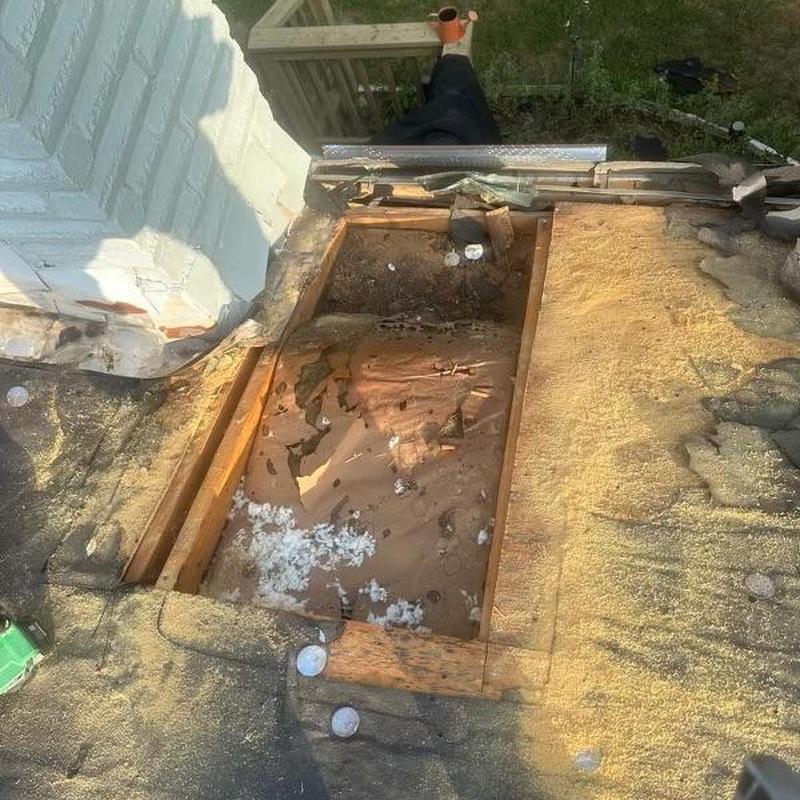 Roof decking with hail and water damage around chimney
