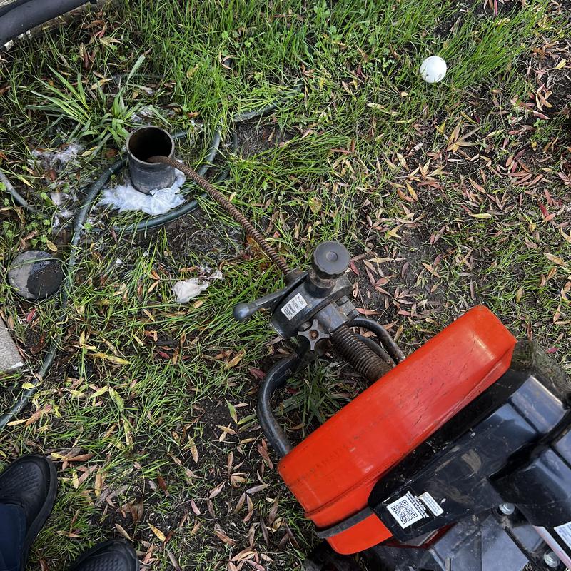 Main sewer clean out with drain snake on grass